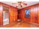 Bedroom with wood paneled walls and hardwood floors at 4116 Haines N Rd, St Petersburg, FL 33703