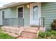 Front entrance with a white door, steps, and an iron railing at 4116 Haines N Rd, St Petersburg, FL 33703