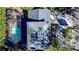 Overhead view of a home with a screened-in pool and surrounding landscape at 4911 W Juno St, Tampa, FL 33629