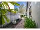 Brick pathway in backyard with potted plants and wooden fence at 4911 W Juno St, Tampa, FL 33629