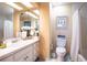 Clean bathroom with white vanity, toilet, and decorative accents at 4911 W Juno St, Tampa, FL 33629