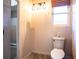 Small bathroom with updated toilet and lighting at 4911 W Juno St, Tampa, FL 33629