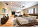 Main bedroom with hardwood floors, large bed, and mirrored wall at 4911 W Juno St, Tampa, FL 33629