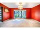 Red dining room with large window and chandelier at 4911 W Juno St, Tampa, FL 33629
