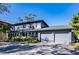 Two-story house with gray siding, landscaped yard, and a two-car garage at 4911 W Juno St, Tampa, FL 33629