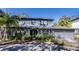 Two-story house with gray siding, landscaped yard, and a two-car garage at 4911 W Juno St, Tampa, FL 33629