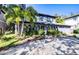 Two-story house with gray siding, double garage, and lush landscaping at 4911 W Juno St, Tampa, FL 33629