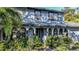 Two-story house with gray siding, double garage, and manicured landscaping at 4911 W Juno St, Tampa, FL 33629