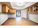 Bright kitchen with wood cabinets, tile floor, and access to backyard patio at 4911 W Juno St, Tampa, FL 33629