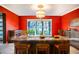 Red-walled kitchen with stainless steel appliances and a large island at 4911 W Juno St, Tampa, FL 33629