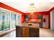 Red-walled kitchen with stainless steel appliances and a large island at 4911 W Juno St, Tampa, FL 33629