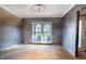 Under construction living room with large window and new flooring at 4911 W Juno St, Tampa, FL 33629