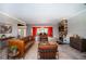 Open concept living room with a view into dining area, a fireplace, and leather sofas at 4911 W Juno St, Tampa, FL 33629