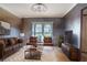 Cozy living room with brown leather furniture, a large window, and a rustic feel at 4911 W Juno St, Tampa, FL 33629