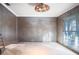 Under construction living room with large window and exposed walls at 4911 W Juno St, Tampa, FL 33629