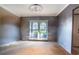 Under construction living room with large window and new flooring at 4911 W Juno St, Tampa, FL 33629