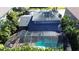 Aerial view of a home with a screened-in pool and backyard at 4911 W Juno St, Tampa, FL 33629