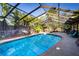 Relaxing screened pool and patio area with lush landscaping at 4911 W Juno St, Tampa, FL 33629