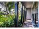 Covered porch entry with brick flooring and lush landscaping at 4911 W Juno St, Tampa, FL 33629