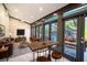 Bright sunroom with multiple glass doors leading to a refreshing pool area at 4911 W Juno St, Tampa, FL 33629