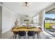 Dining area with wood table, black chairs, and view of the backyard at 5052 Ivory Stone Dr, Wimauma, FL 33598