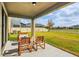 Covered patio with seating area overlooking backyard at 5052 Ivory Stone Dr, Wimauma, FL 33598