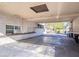 Covered carport with concrete flooring and built-in workspace at 6626 1St N St, St Petersburg, FL 33702