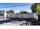 Side view of a white stucco wall enclosing a parking area at 6626 1St N St, St Petersburg, FL 33702