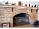 Brick fireplace with decorative mantel and ornate screen at 6626 1St N St, St Petersburg, FL 33702