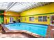 Bright, enclosed pool with colorful walls and tiled flooring at 6626 1St N St, St Petersburg, FL 33702