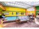 Relaxing indoor pool area with colorful walls and comfortable seating at 6626 1St N St, St Petersburg, FL 33702