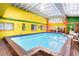 Bright, colorful solarium with a large indoor pool at 6626 1St N St, St Petersburg, FL 33702