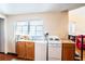 Simple kitchen with white appliances and wooden cabinets at 6626 1St N St, St Petersburg, FL 33702