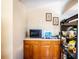 Small kitchen with microwave, sink, and wooden cabinets at 6626 1St N St, St Petersburg, FL 33702