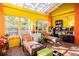 Bright sunroom with lounge chairs and a workspace at 6626 1St N St, St Petersburg, FL 33702
