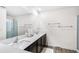 A spacious bathroom is equipped with double sinks, dark cabinets and a walk-in shower at 5327 New Friendship Pl, Tampa, FL 33619
