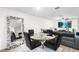 Dining area with a round glass table, elegant chairs, and a large decorative mirror at 5327 New Friendship Pl, Tampa, FL 33619