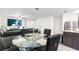 Open concept dining area featuring a glass table with black seating adjacent to the kitchen at 5327 New Friendship Pl, Tampa, FL 33619
