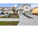 Modern townhomes featuring well-maintained lawns and two-car garages, plus stylish landscaping, and neutral color schemes at 5327 New Friendship Pl, Tampa, FL 33619