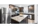 Updated kitchen with granite countertops, stainless steel appliances, and stylish cabinetry with a kitchen island at 5327 New Friendship Pl, Tampa, FL 33619