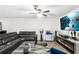 Spacious living room featuring modern décor, sleek furniture, and a fireplace with a large screen tv above it at 5327 New Friendship Pl, Tampa, FL 33619