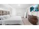 A serene main bedroom showcases a plush bed and modern furnishings under soft, natural light at 5327 New Friendship Pl, Tampa, FL 33619