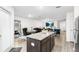 Open-concept layout connecting kitchen, dining, and living areas, featuring modern décor and stainless steel appliances at 5327 New Friendship Pl, Tampa, FL 33619