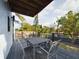 Back porch with outdoor dining set and tree views at 1793 N Fort Harrison Ave, Clearwater, FL 33755