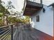 Back porch with outdoor dining set overlooks trees and the backyard at 1793 N Fort Harrison Ave, Clearwater, FL 33755