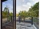 Relaxing back porch with black metal bar style railing overlooking yard at 1793 N Fort Harrison Ave, Clearwater, FL 33755