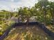Aerial view of a fenced backyard with mature trees, offering privacy and a serene outdoor space at 1793 N Fort Harrison Ave, Clearwater, FL 33755