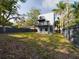 View of modern home with balconies and spacious fenced backyard, offering a private outdoor retreat at 1793 N Fort Harrison Ave, Clearwater, FL 33755