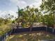 Aerial view of a fenced backyard with mature trees, offering privacy and a serene outdoor space at 1793 N Fort Harrison Ave, Clearwater, FL 33755