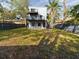 Modern home with balconies overlooking fenced yard and green space, ideal for outdoor enjoyment at 1793 N Fort Harrison Ave, Clearwater, FL 33755